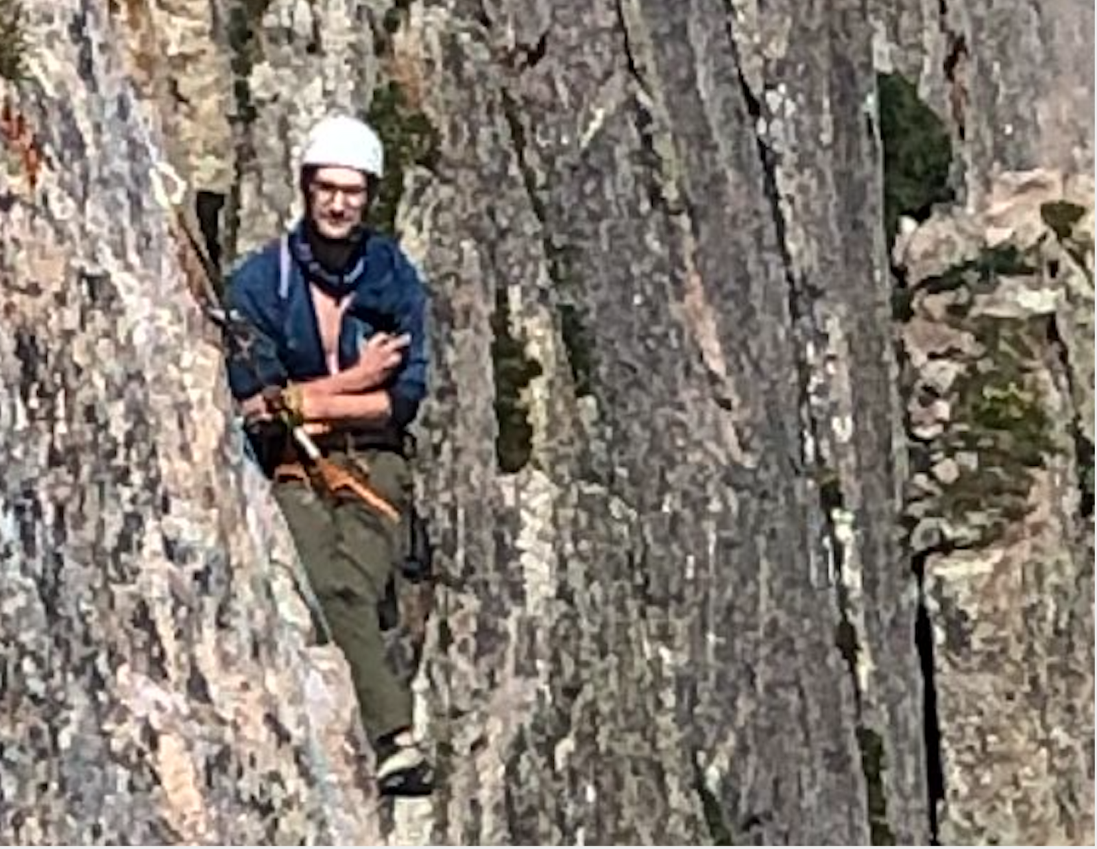 Climber looking unamused in hanging belay on the Diamond, Longs Peak
